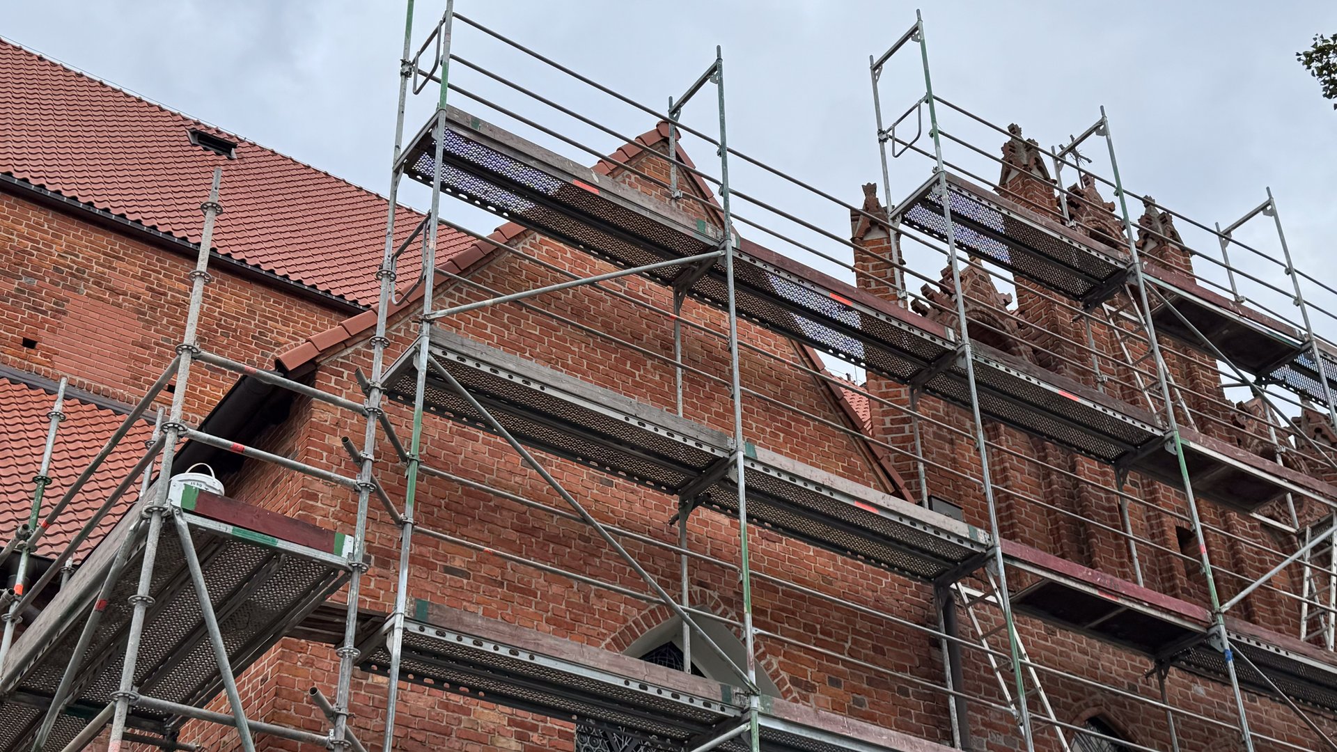 Scaffolding around a brick building under restoration