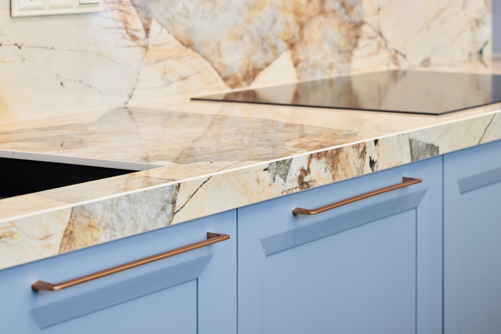Kitchen with marble countertop and blue cabinetry